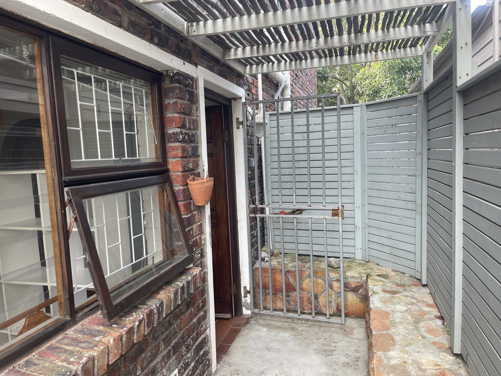 The entrance is a protected spot for morning coffee.