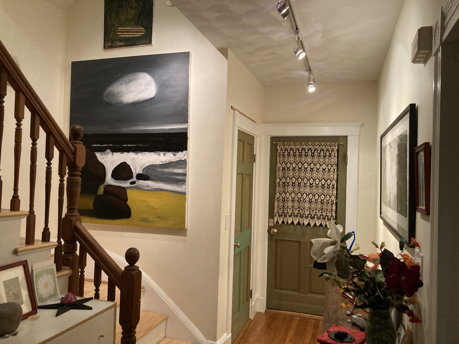 2nd floor hallway to front porch. The door on the left is a closet. The doorway in the foreground, o ...