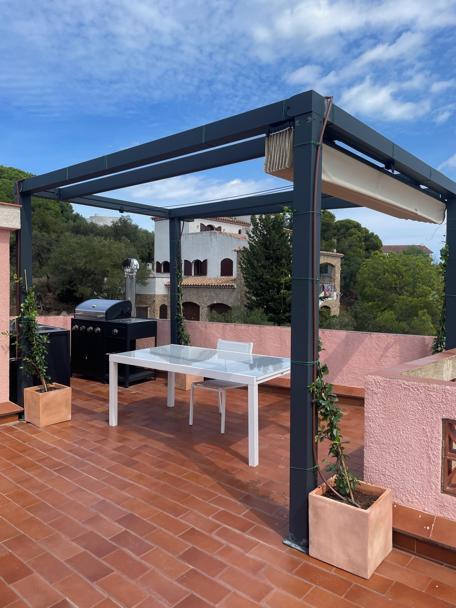 Cozinha ao ar livre e área para churrasco no extenso terraço