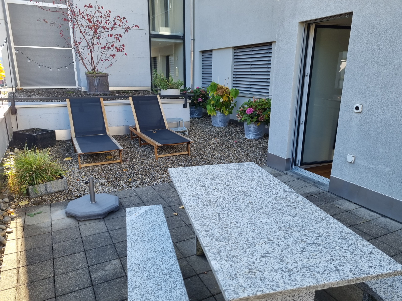 Spacious terrace with sun loungers and table