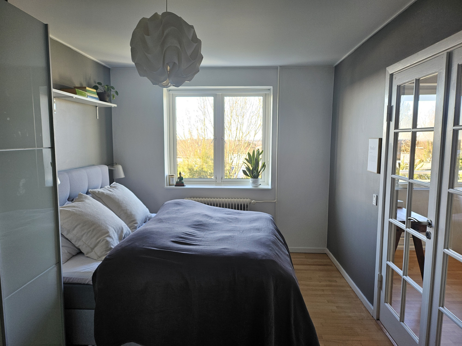 Bedroom with view of the rooftops of the city.