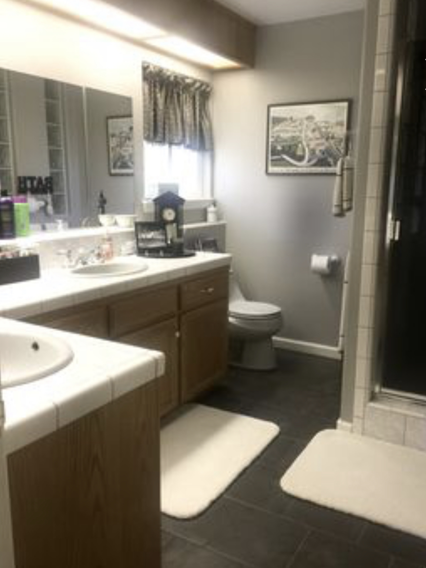 Downstairs bathroom with double sinks and walk-in shower.