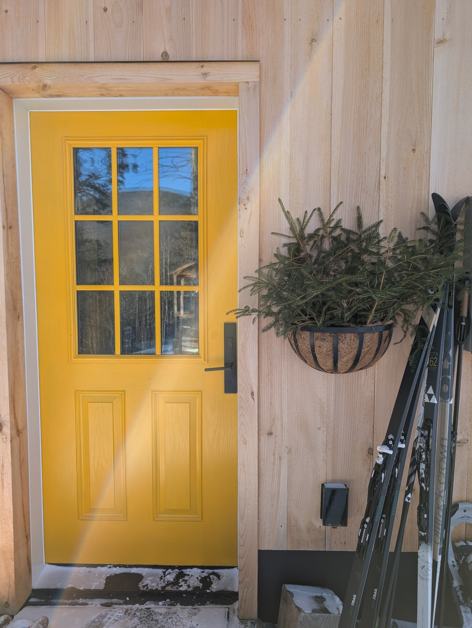 Front door with cross-country skis and snowshoes in the winter