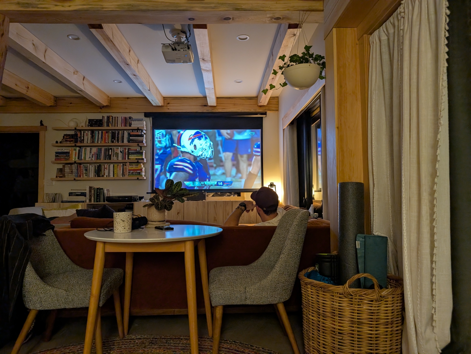 Living room with projector on, which can retract out of view