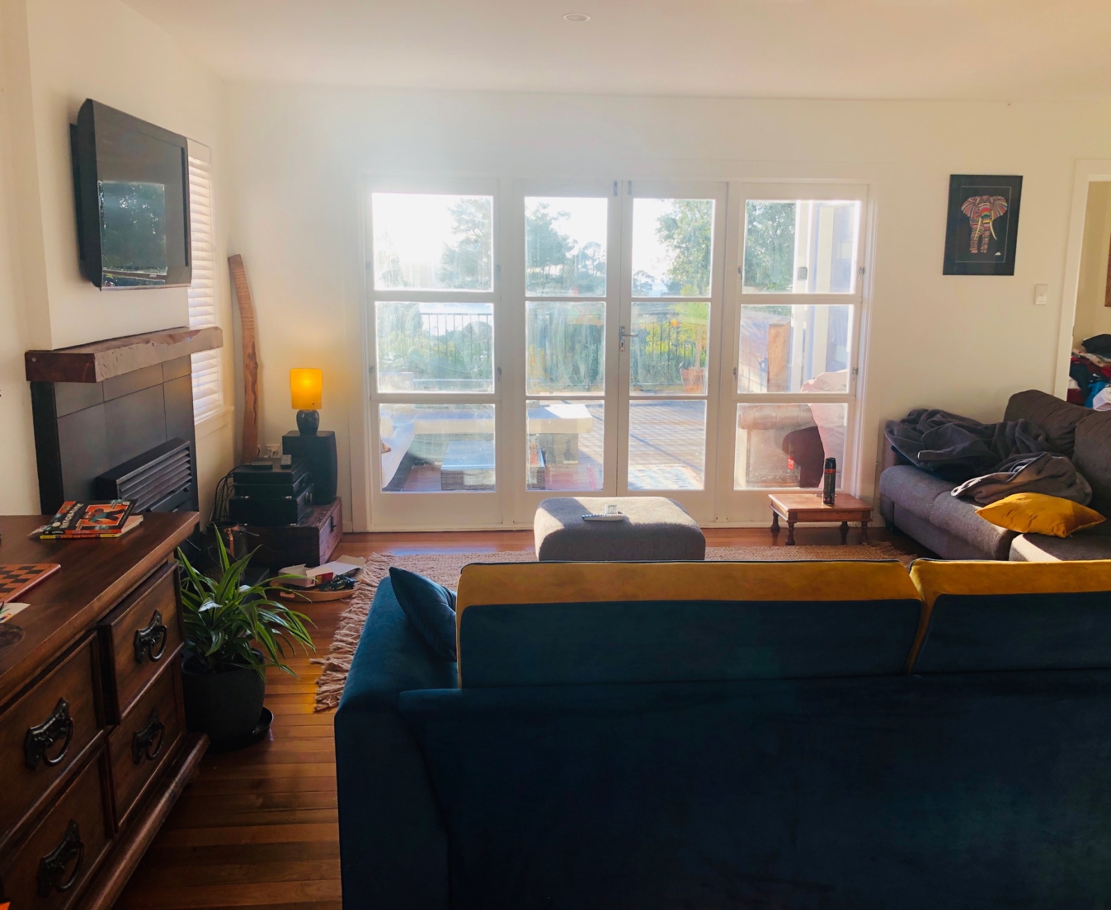 Open-plan lounge with two 3-seater sofas and smart TV