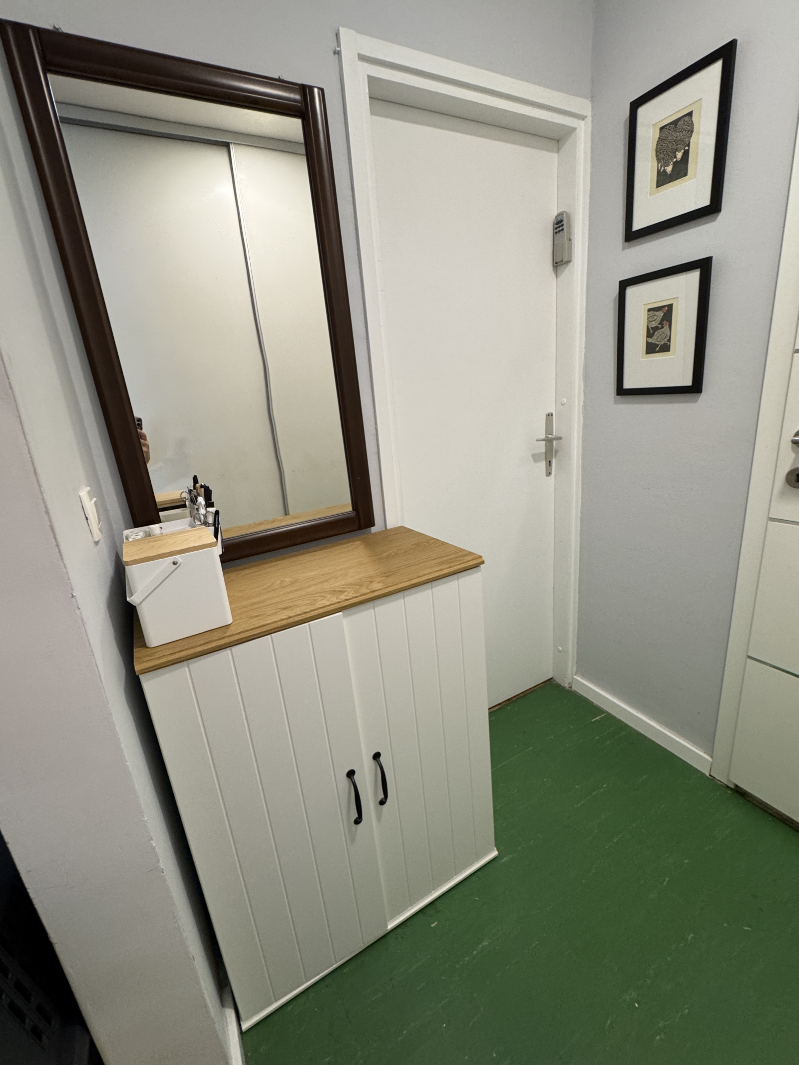 The small hallway outside the bedroom and bathroom has a second mirror and dressing table that is pe ...