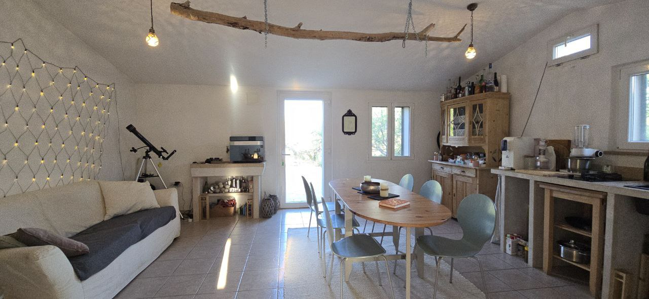 Spacious living room with kitchen, sleeping couch, wood stove for winterperiods. 
View 1