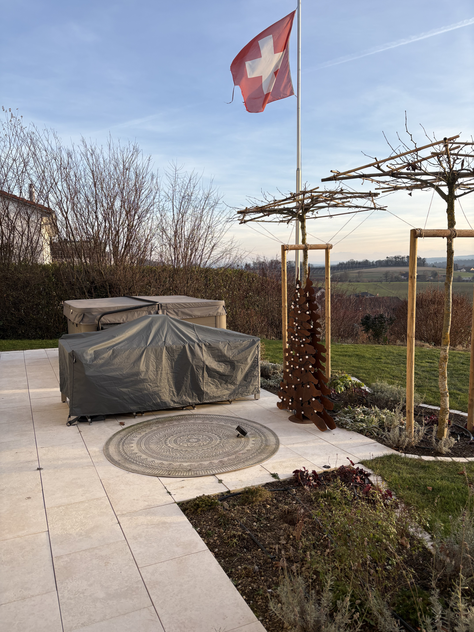 Dining table pulls out to hold 12 people in the shade of the trees