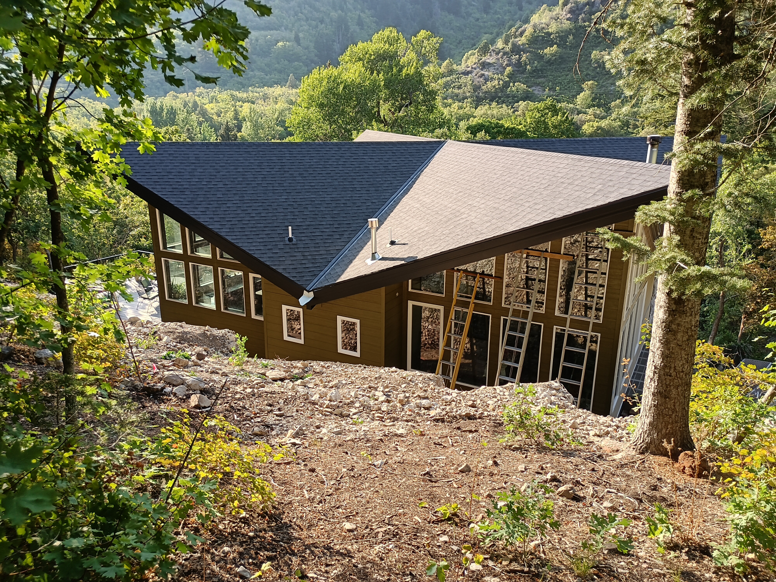 Rear view of house with Kitchen windows on left and Master bedroom windows on right.