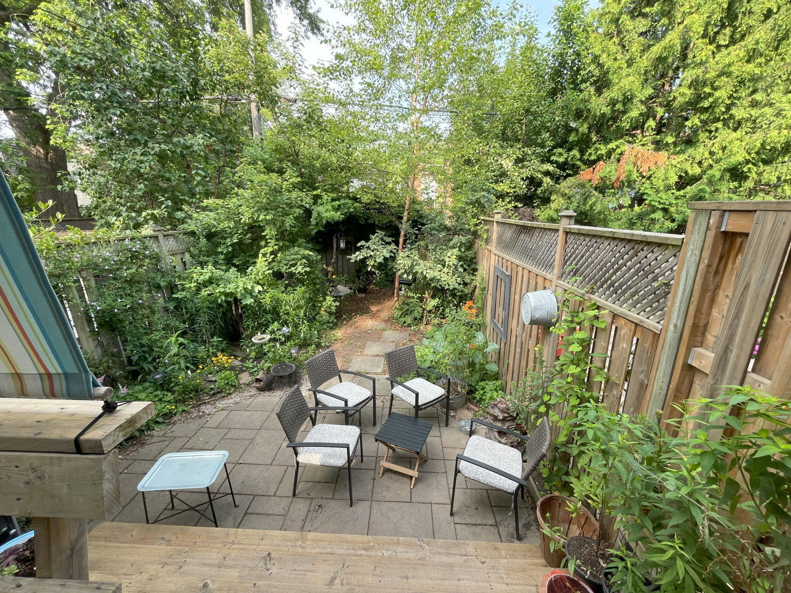Backyard urban oasis with shade and native plants. Eating area on deck and more seating on the small ...