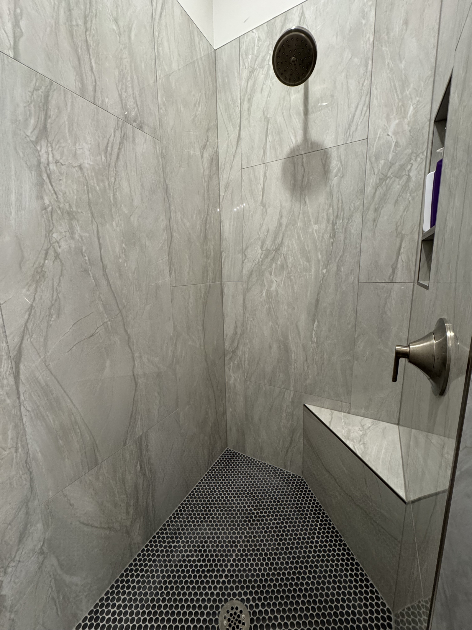 Salle de bain attenante à droite, douche avec articles de toilette