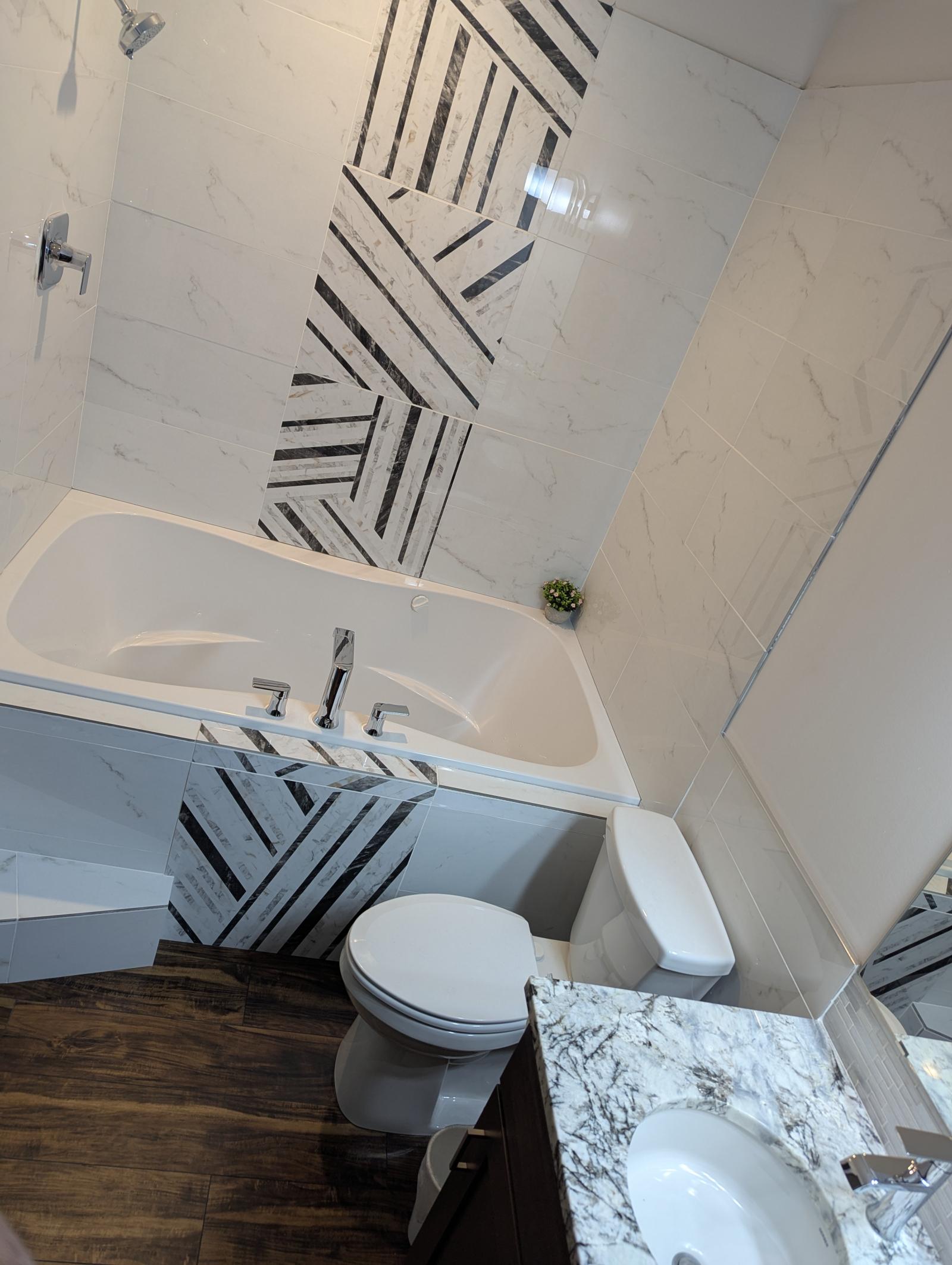 Bathroom off second bedroom, showing two-person, heated, soaking tub with water jets and shower abov ...