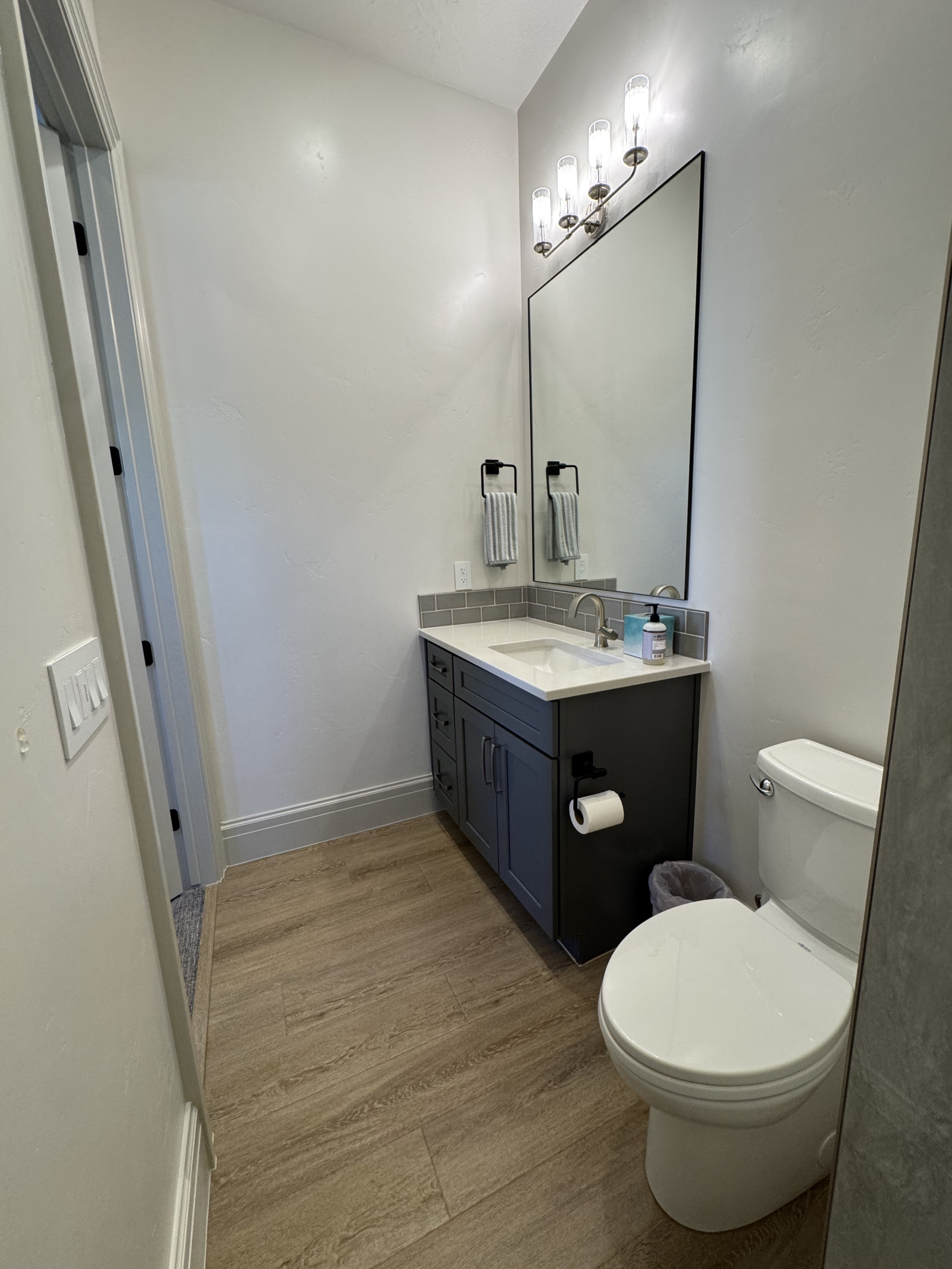 Salle de bain attenante à gauche. Les serviettes sont sous le lavabo, les articles de toilette dans ...