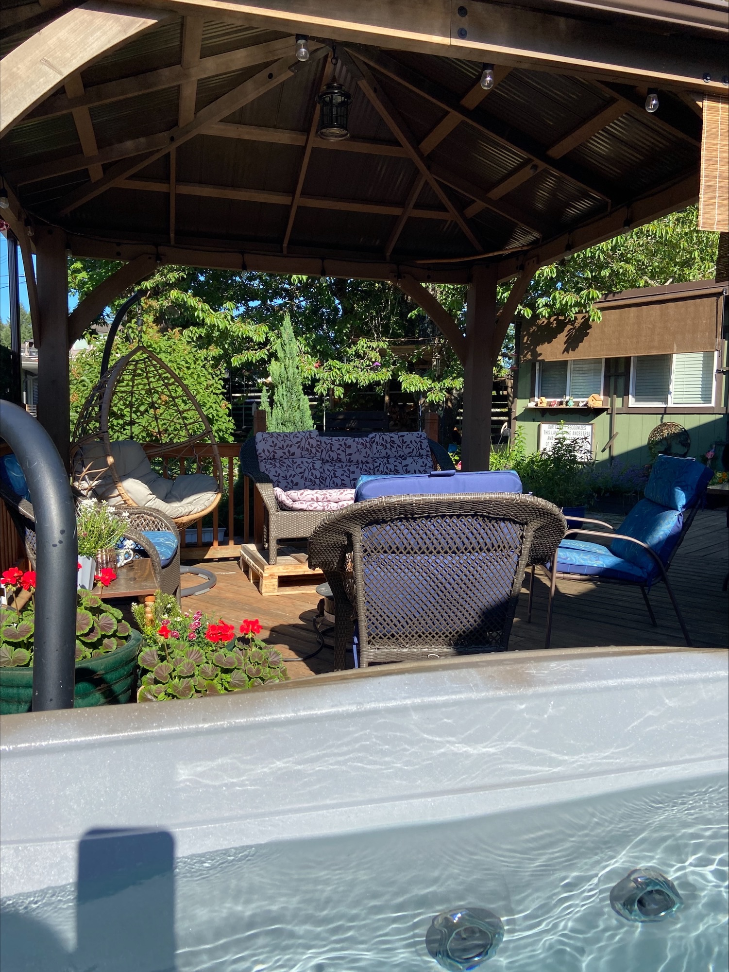 Covered patio looking towards back yard from hot tub