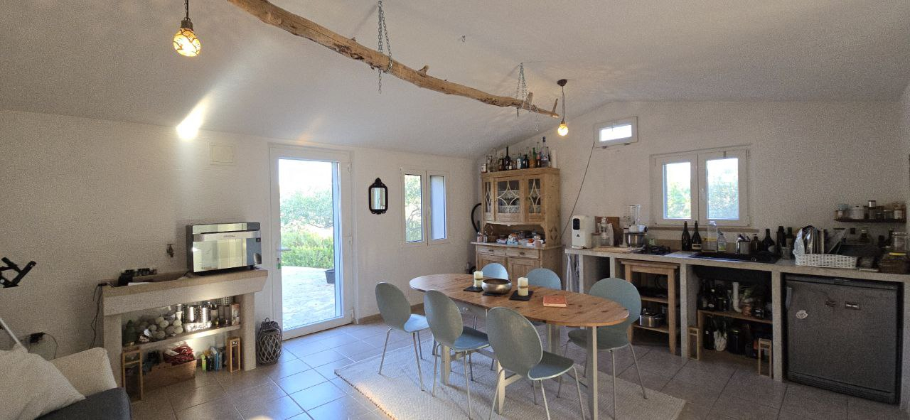 Spacious living room with kitchen, sleeping couch, wood stove for winterperiods. 
The kitchen inclu ...