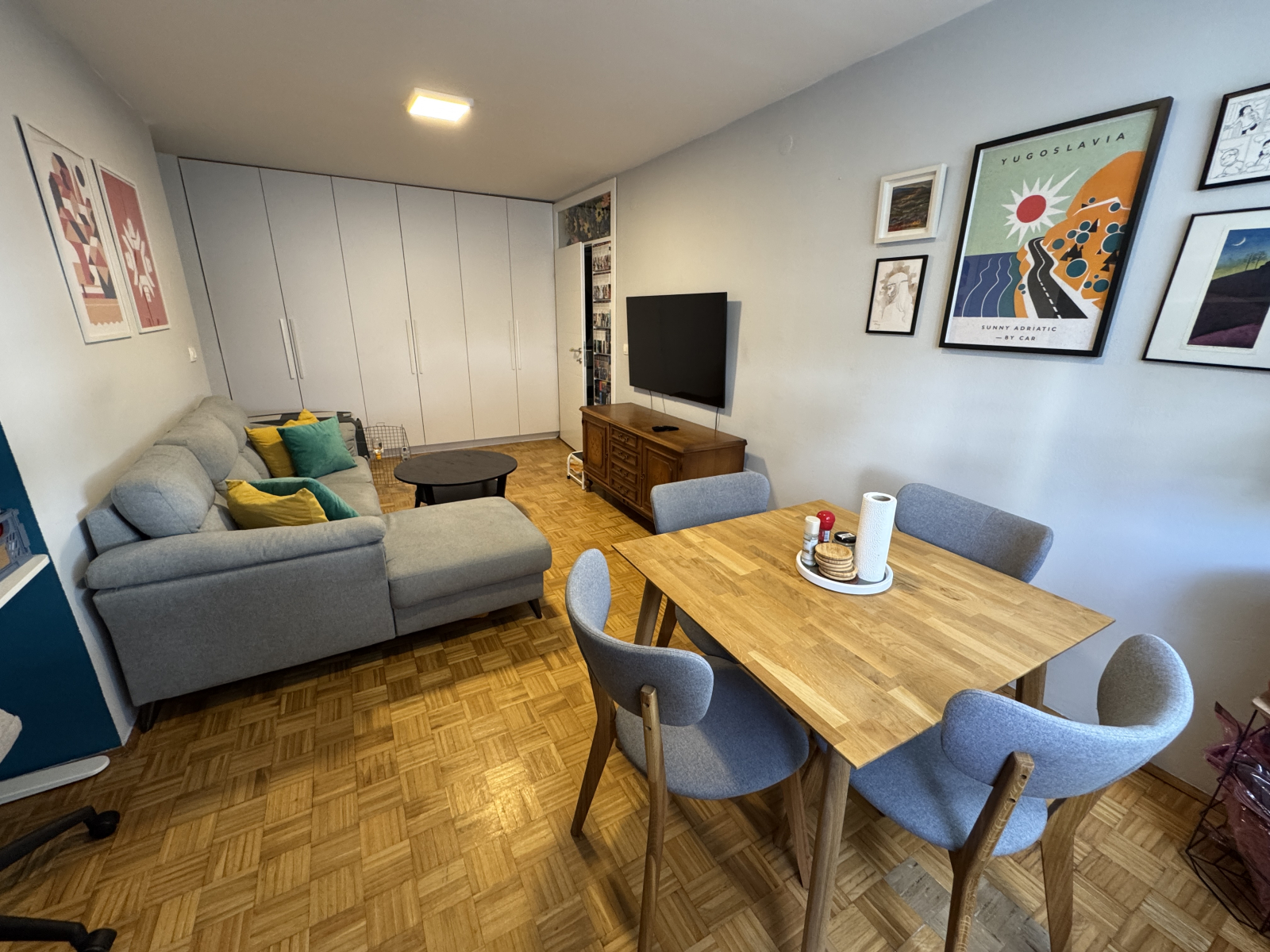 View of the dining area and living room (including the pull out couch and tv with streaming).  The f ...
