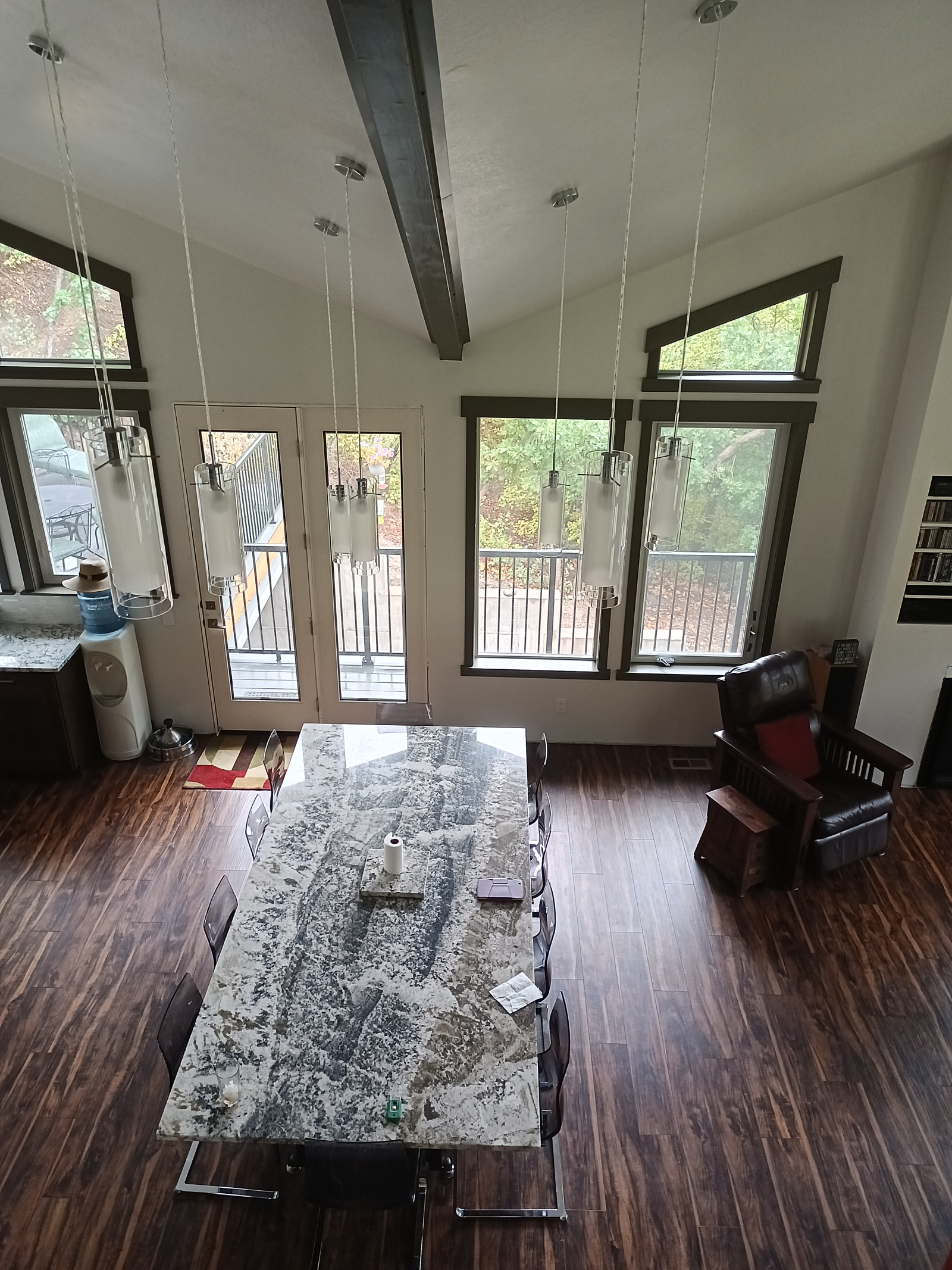 View from the mezzanine of the dining room table (seats ten) with the kitchen and the door to the ba ...