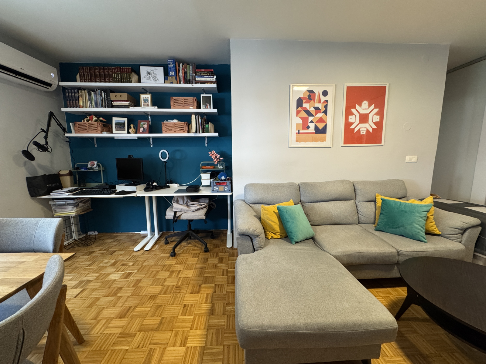 View of the work area and living room couch (which pulls out).  The posters on the right are from lo ...