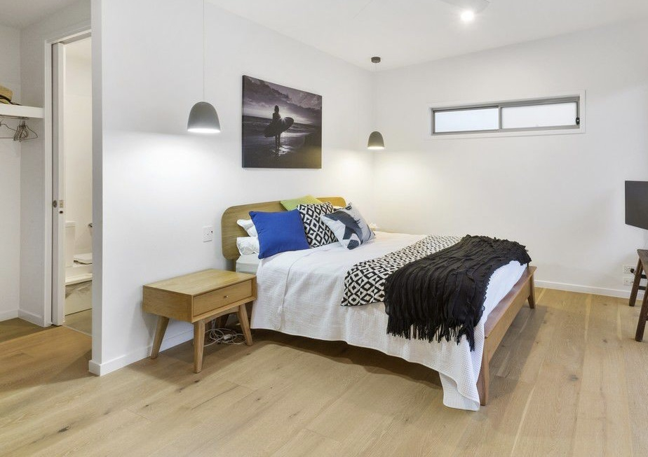 Bedroom 1 with own ensuite, opens to central breezeway and has deck to pool garden.