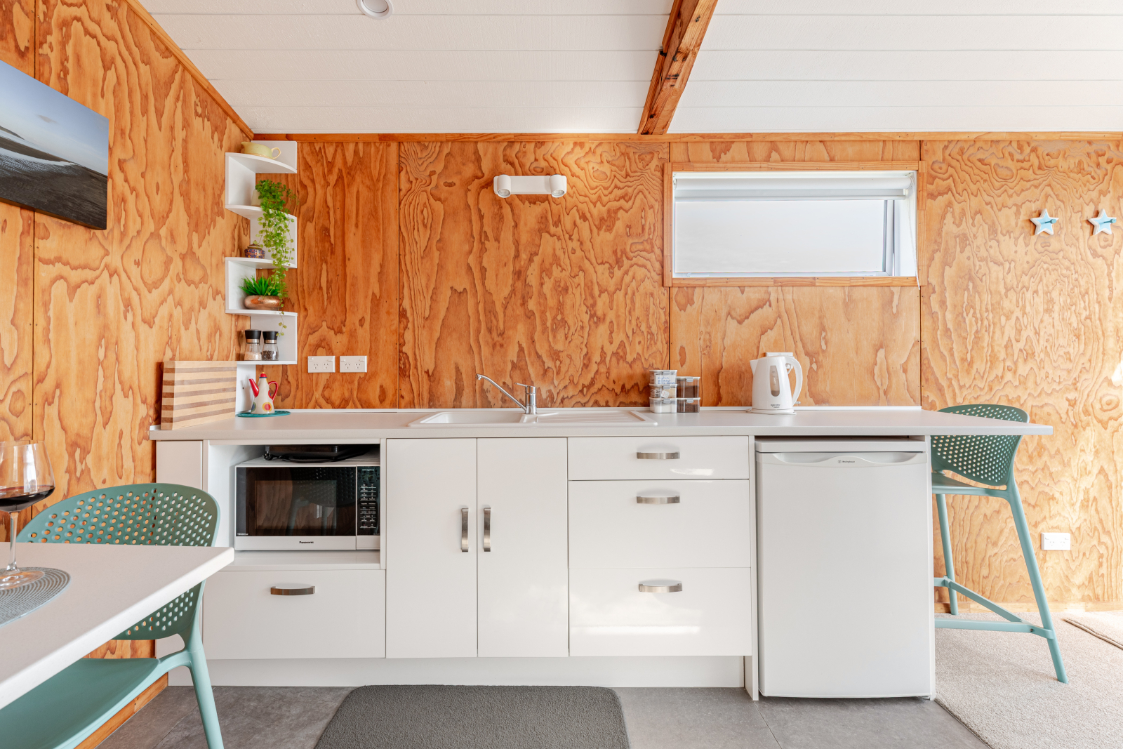 Simple kitchen with single hob, air fryer and microwave.