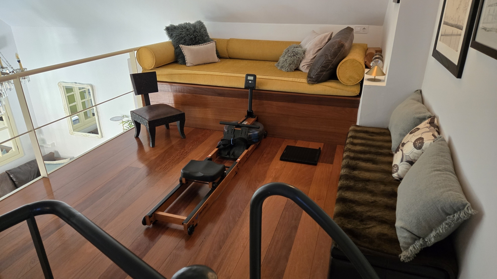 Open plan mezzanine with day bed and rowing machine