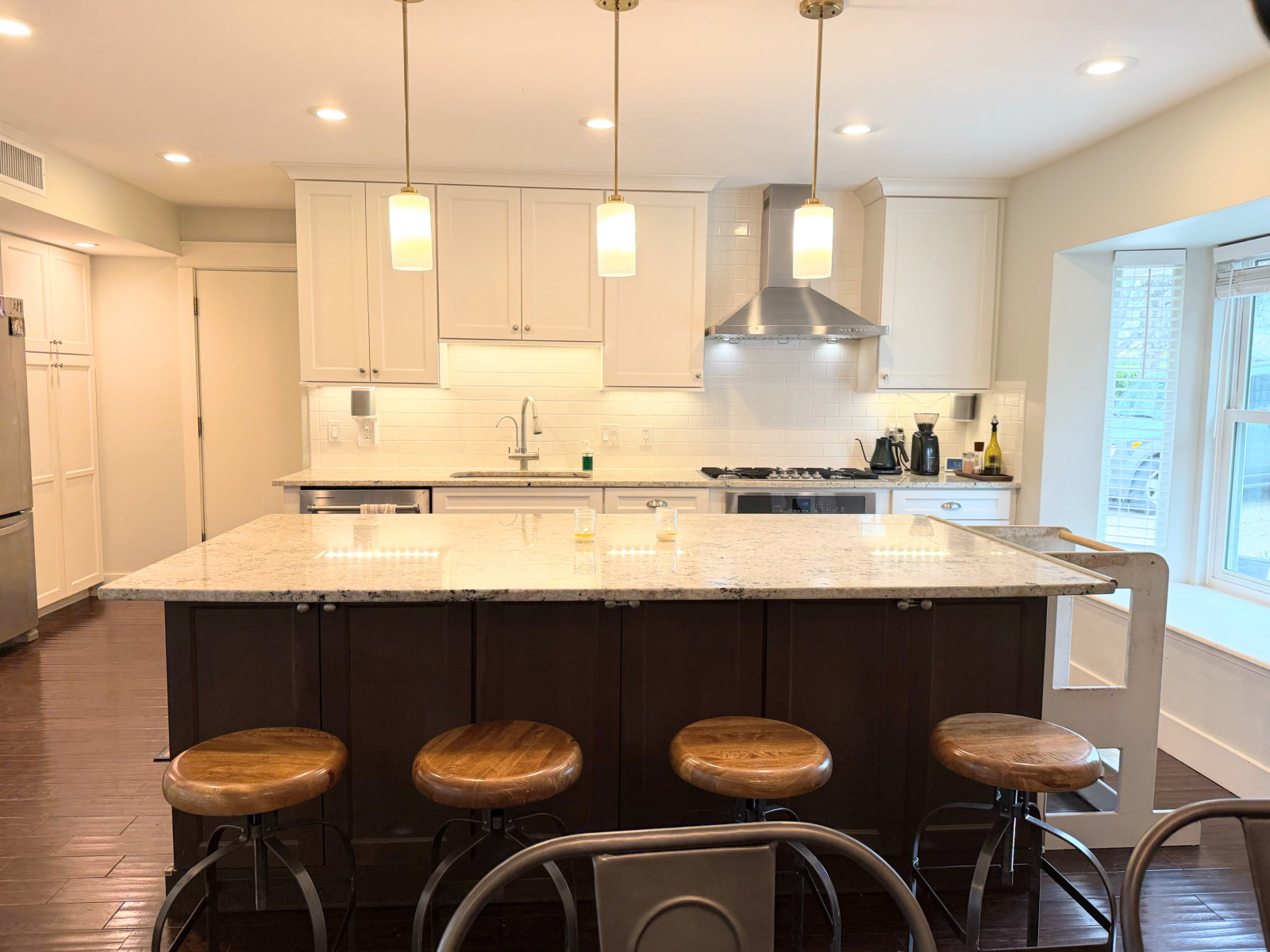 Chef's kitchen with gas stove 3-level dishwasher, and lots of seating.