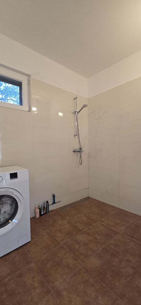Right side of the bathroom with spacious open shower.