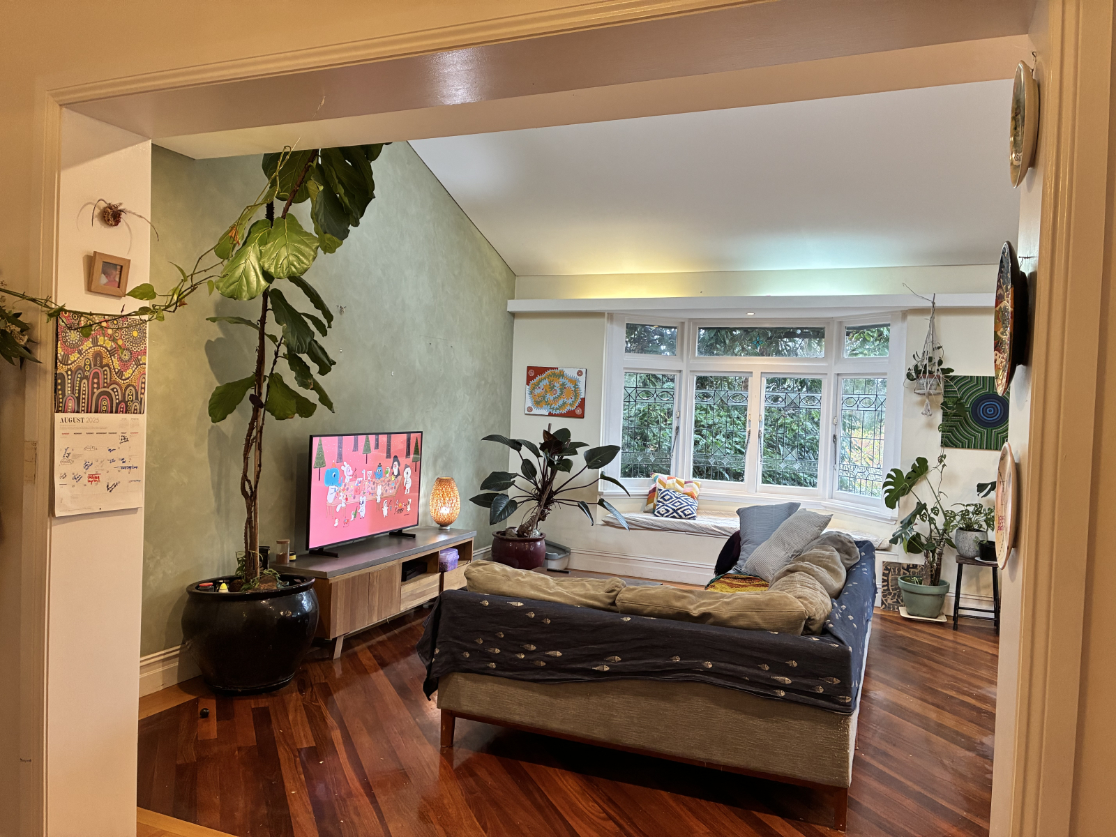 Lounge room facing onto entertainers veranda and lush big dog friendly backyard with avocado, melale ...