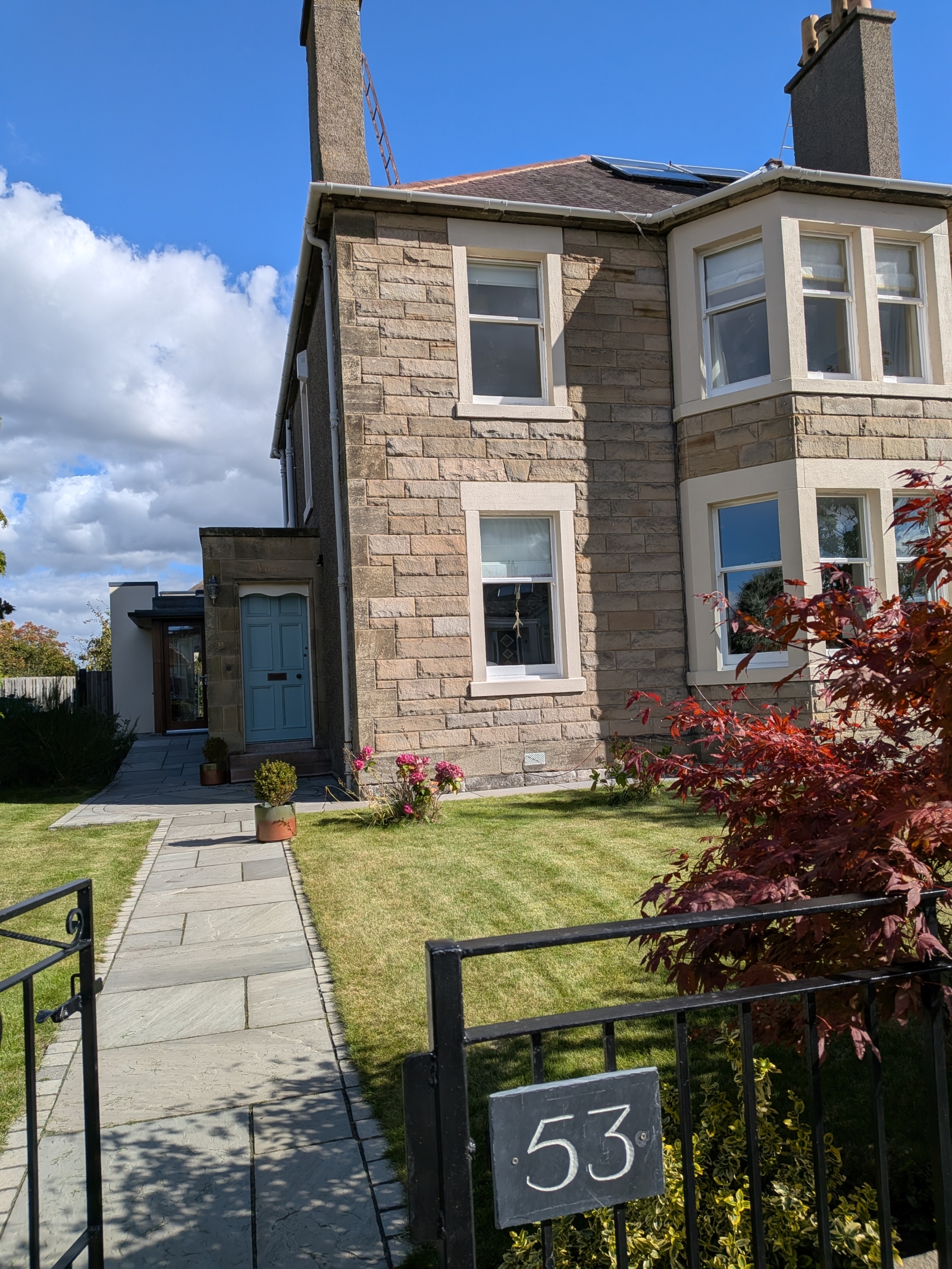Our home. There are two entrances, one through the green door, and the other one (very useful for prams and luggage) through a glass door to the left.