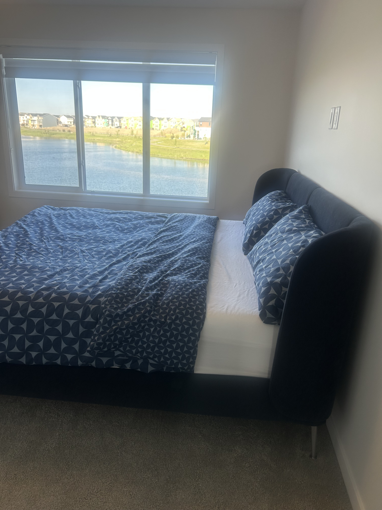 Master bedroom with stunning pond views and a king-size Tempur-Pedic mattress for ultimate comfort