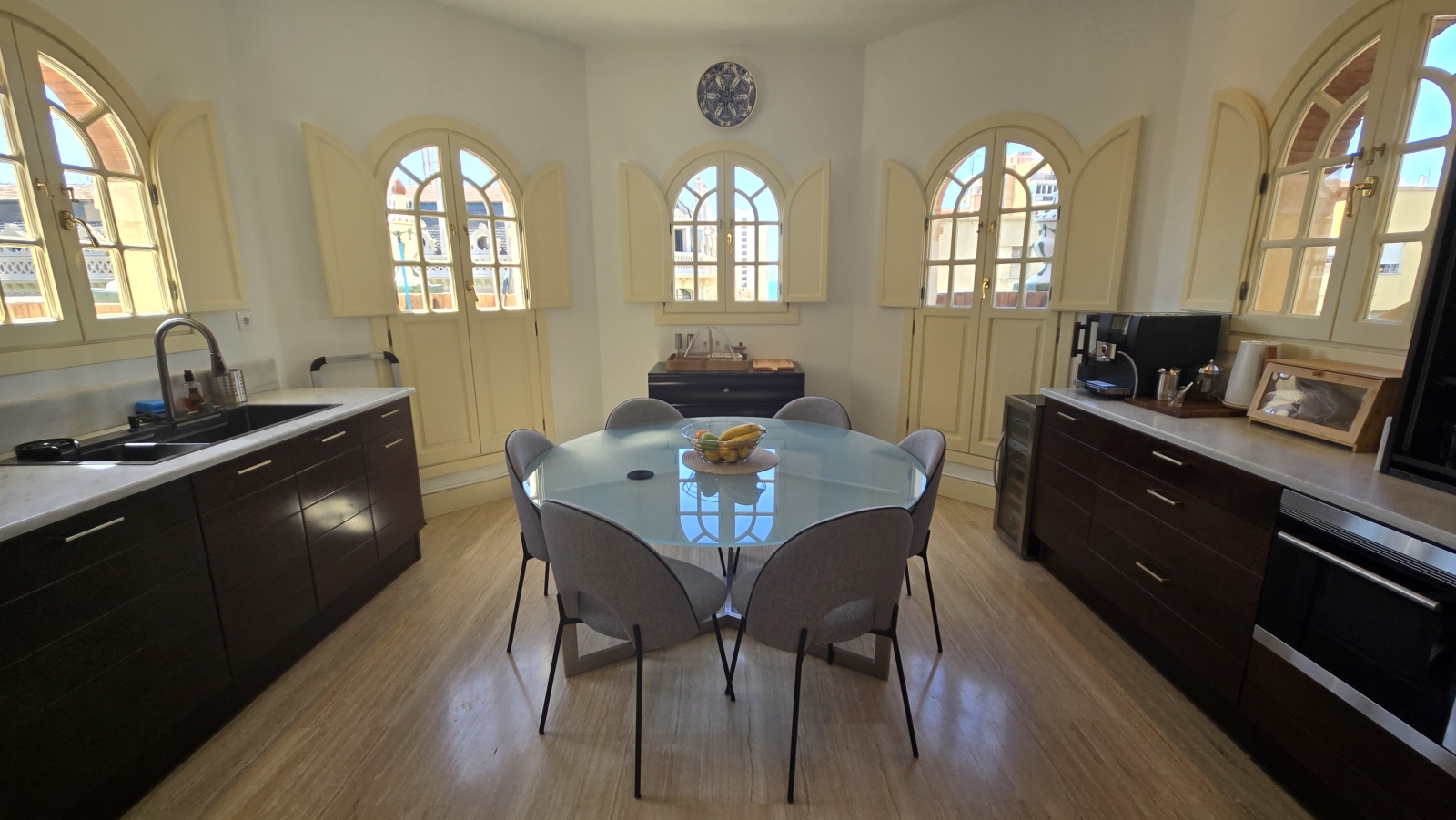 A bright kitchen with 2 small balconies
