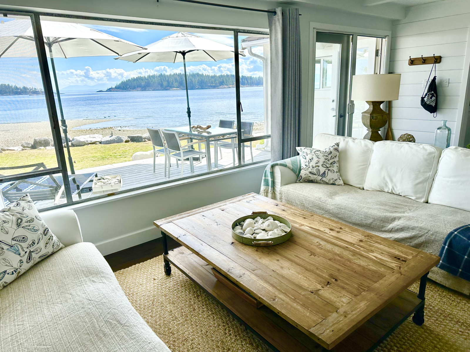 Living room with picture window, fireplace, Sonos speaker sound system and TV