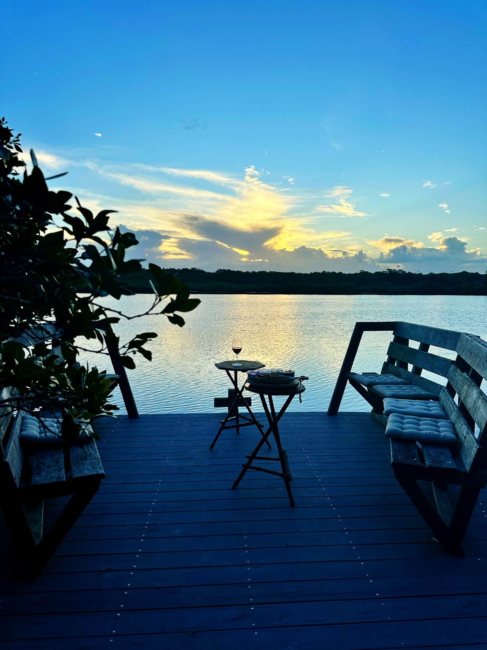 Belongil Creek and our private jetty, stand up paddle boards and kayaks on top deck of jetty