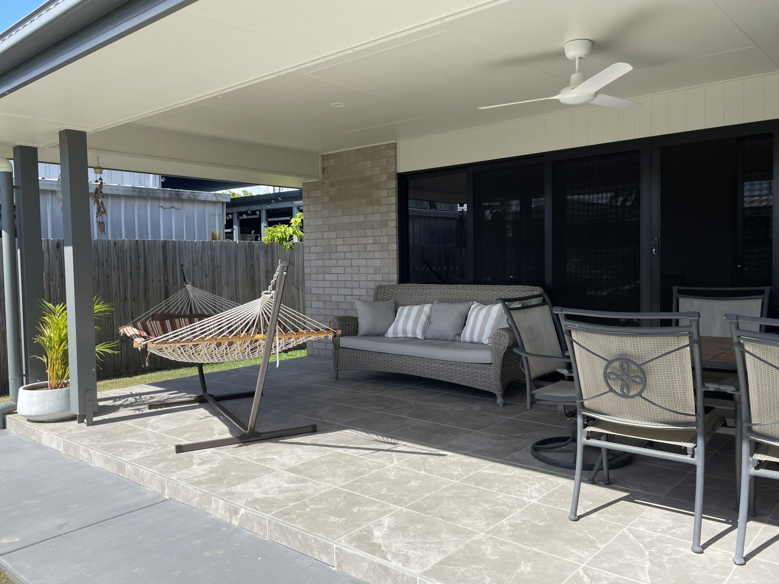 Alfresco with outdoor table and 6 chairs, couch, hammock, BBQ, second fridge.