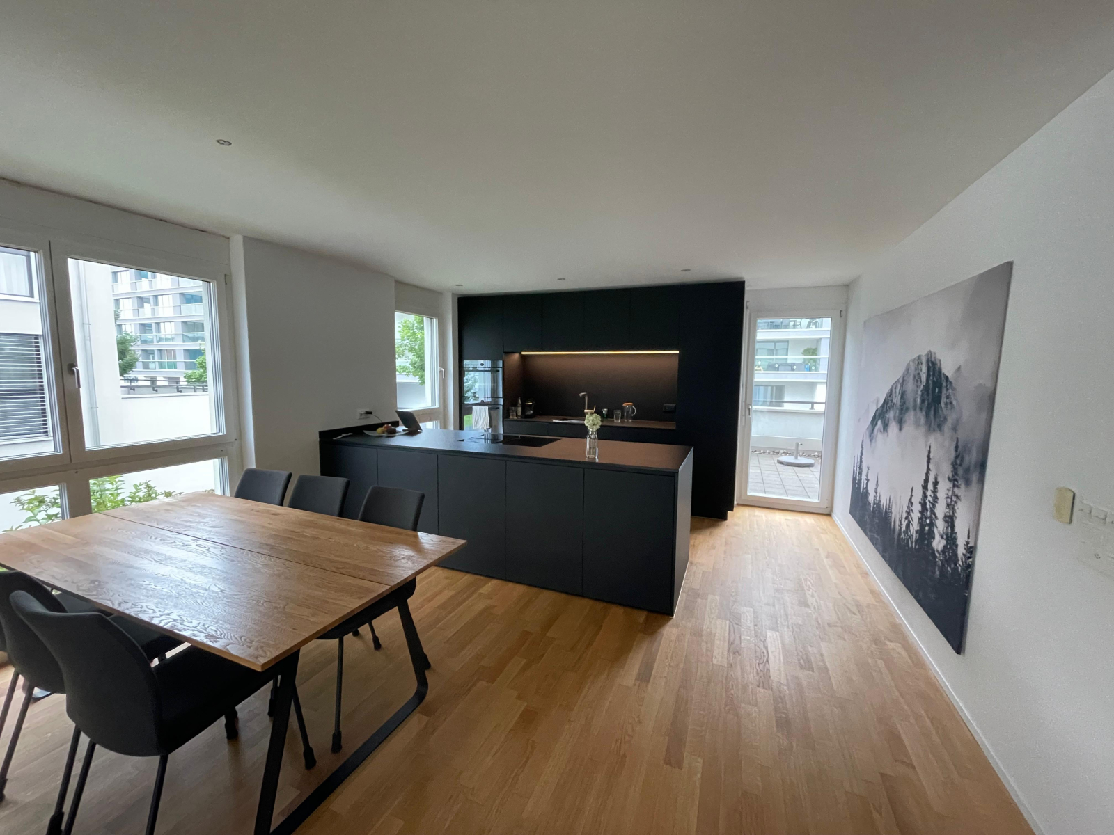More open living area with a modern kitchen