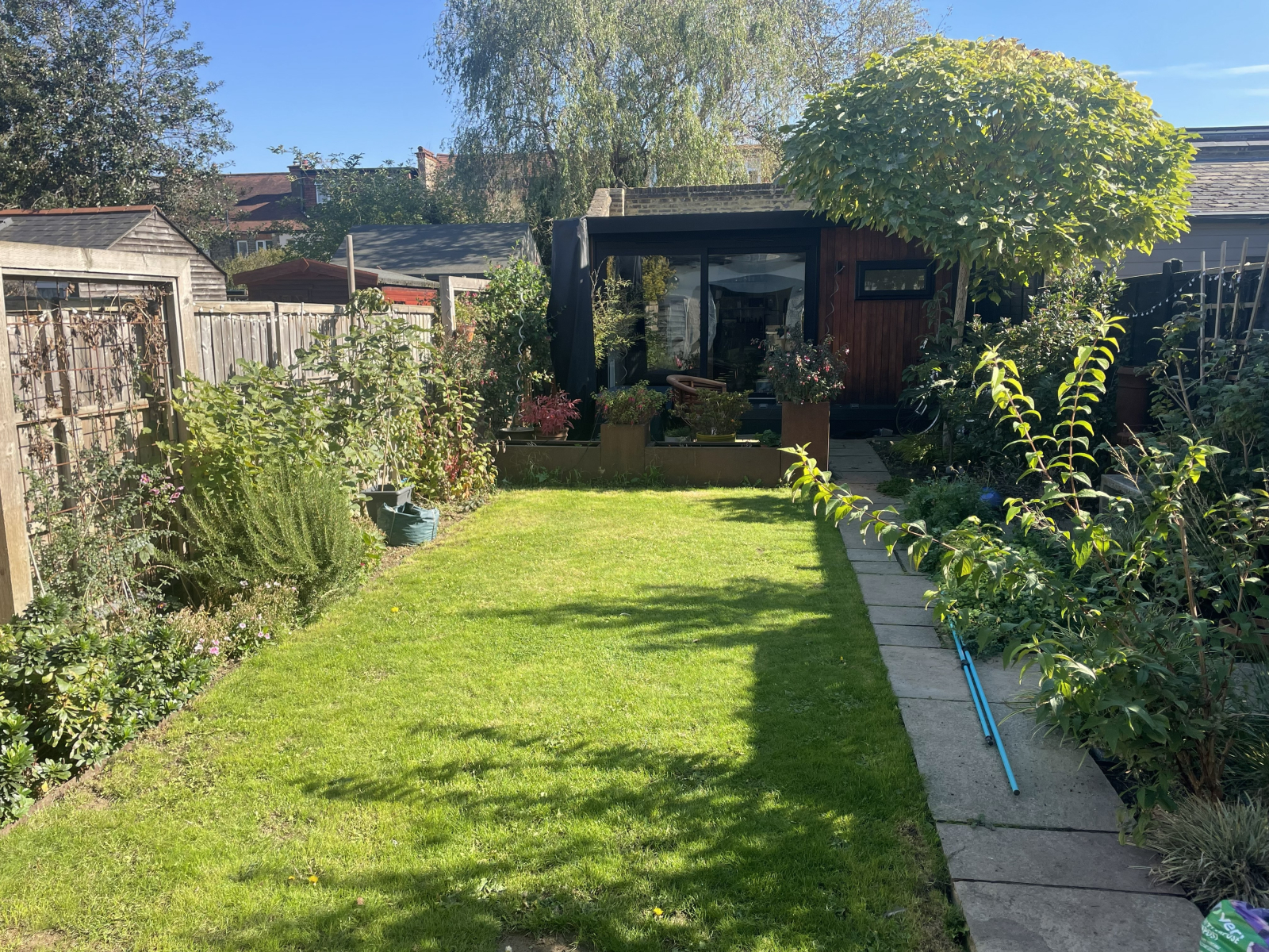 Back garden from the kitchen looking towards the studio and patio area.