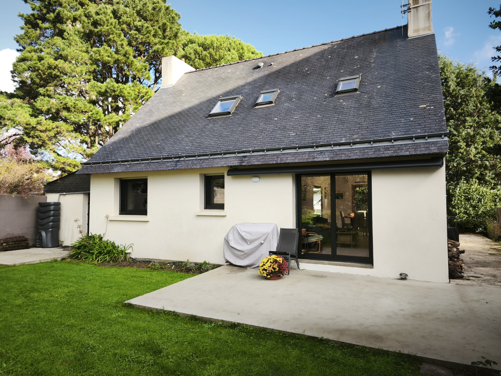 Rear of house which faces West.  Patio, awning and barbecue.