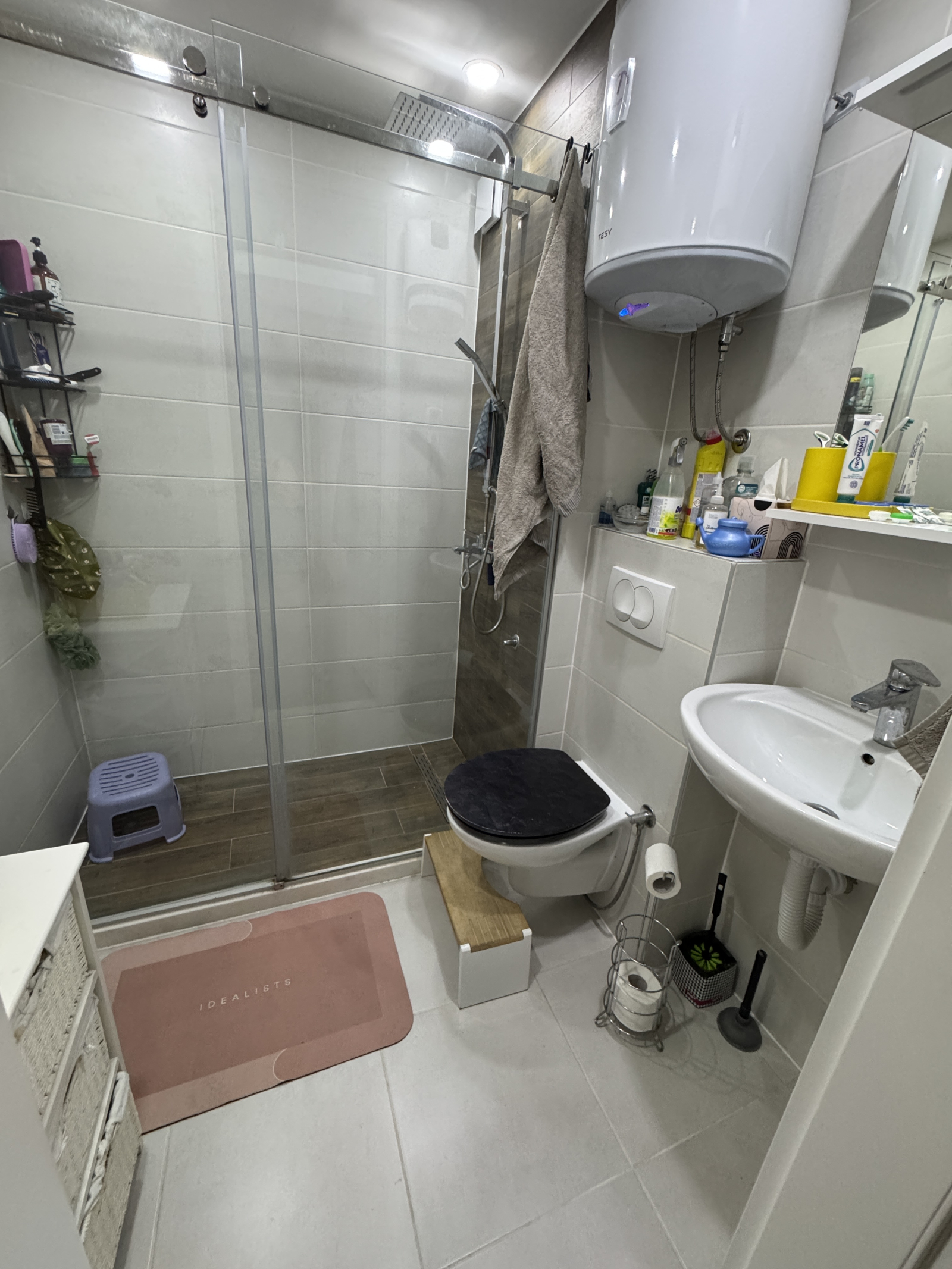 The bathroom features a walk in shower.
