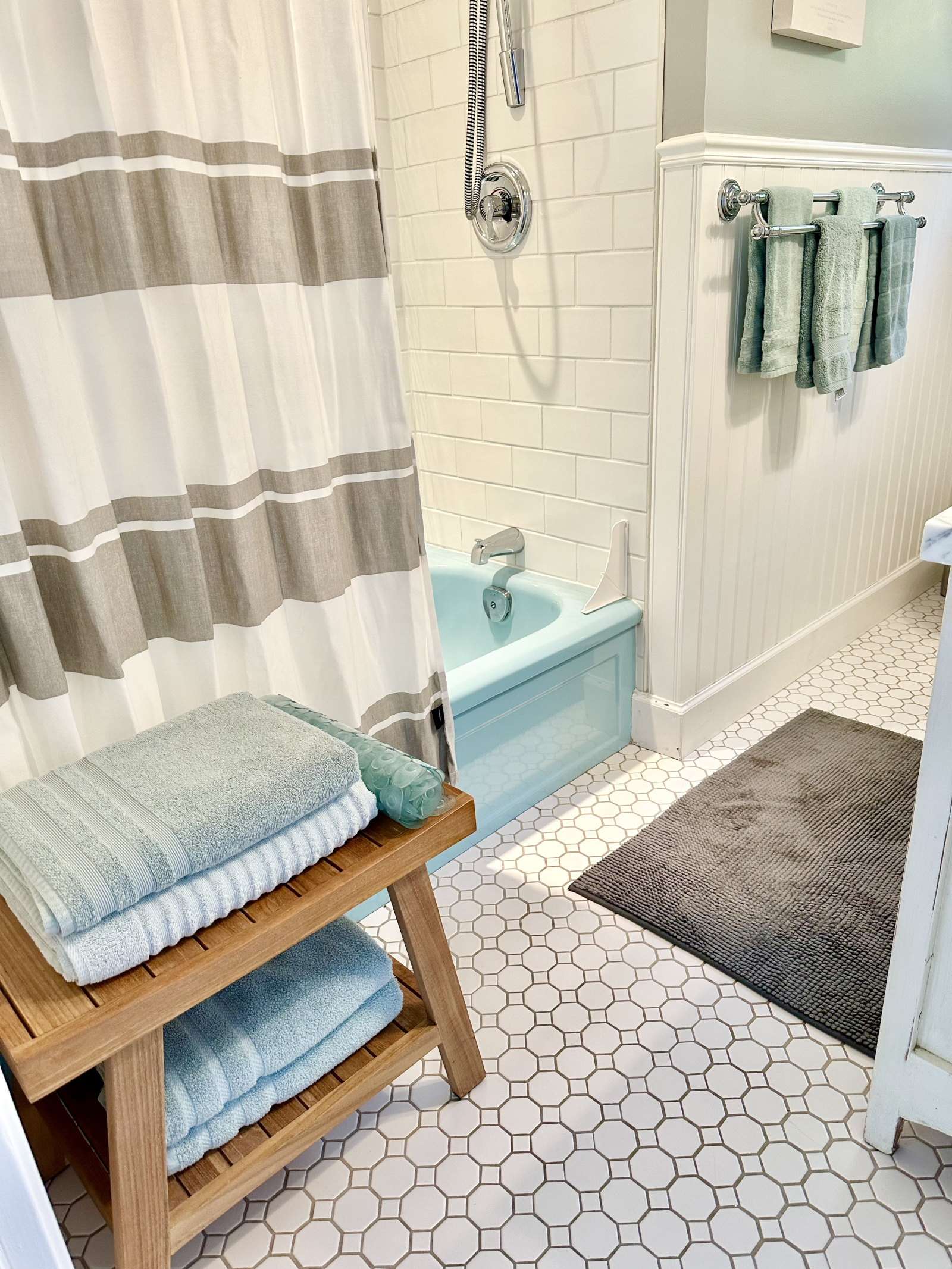 Bathroom with vintage tub with modern shower.