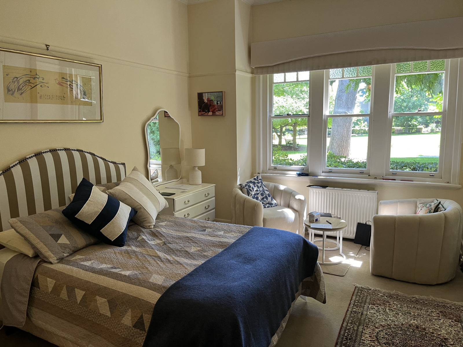 Master bedroom, looking out onto the Village Green, with a couple of cosy armchairs where we drink t ...