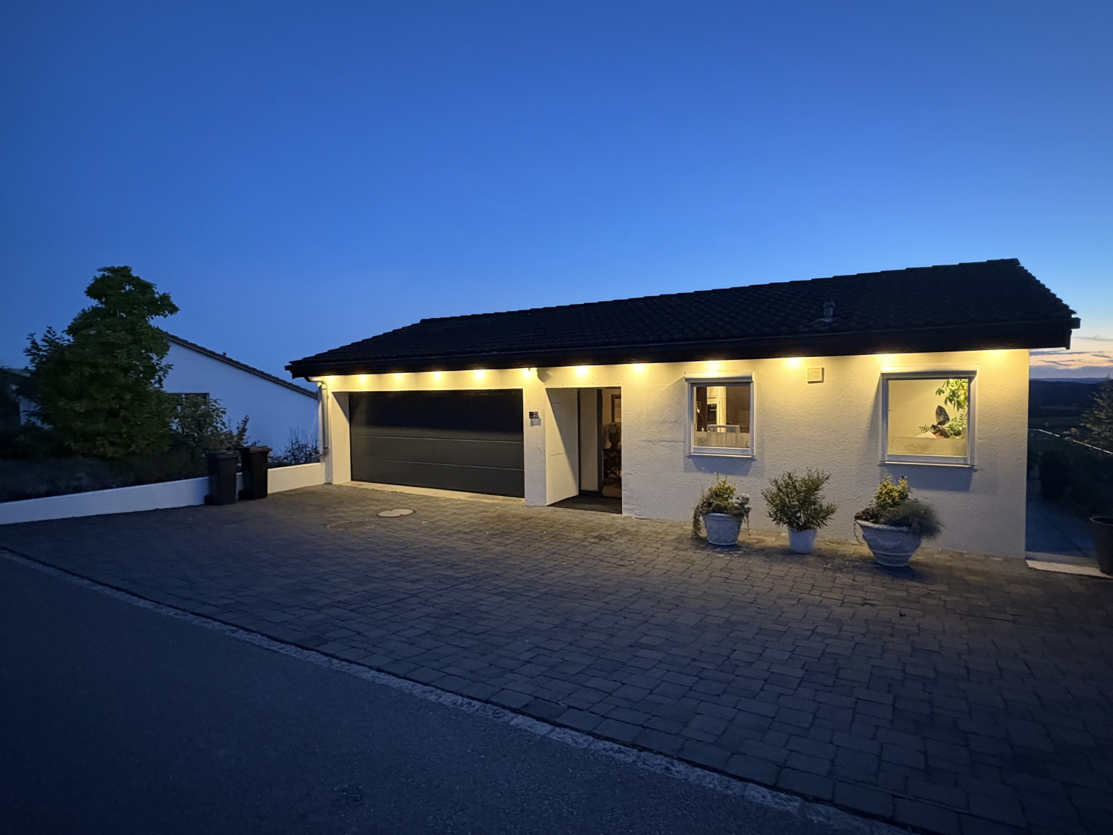 Large driveway at the front, double garage and kitchen windows