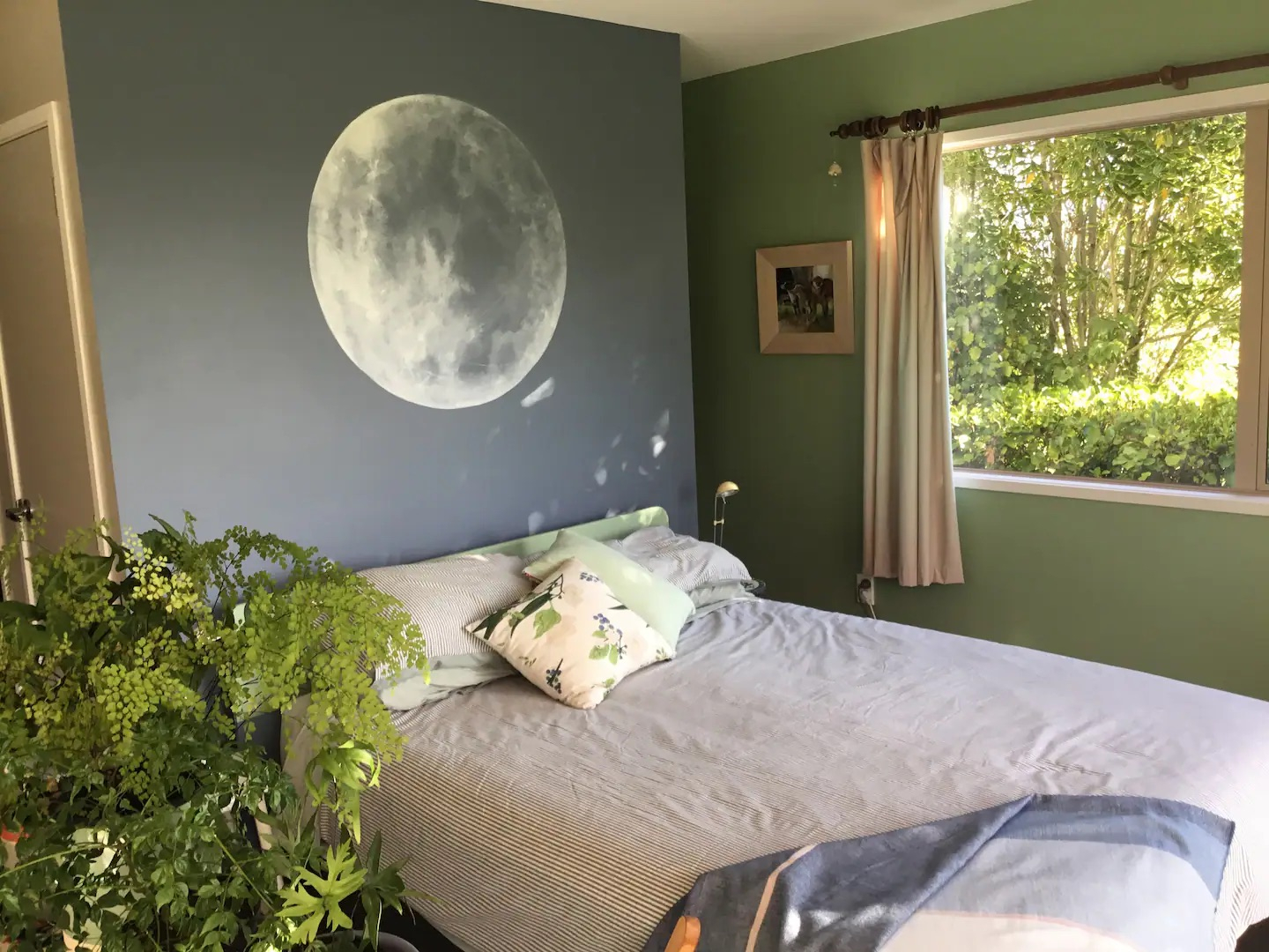 Comfortable Queen bed and blue moon by the artist owner.