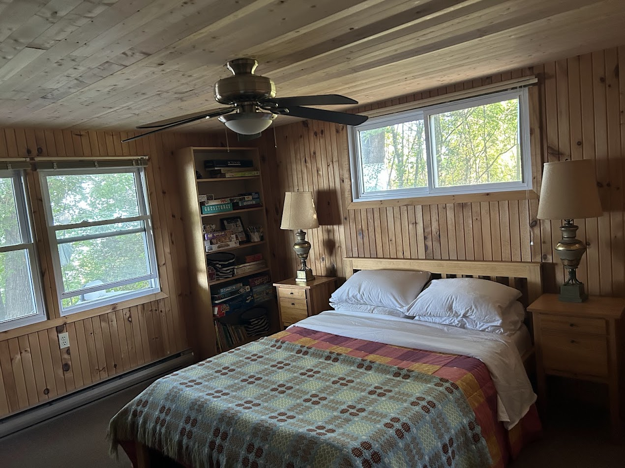 Main floor bedroom with a queen-size bed, dresser, closet, and the soothing sounds of the waves.