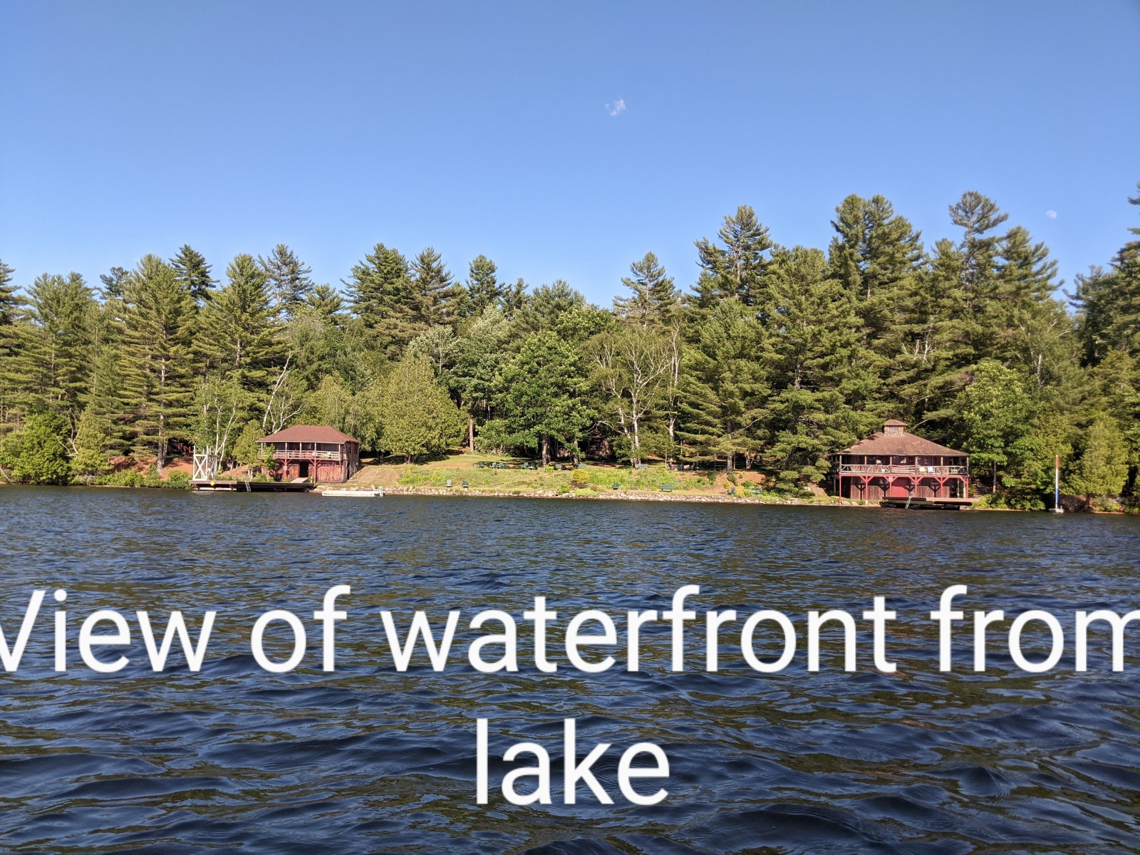 Family cabin at former sleepaway camp with docks, kayaks, and field