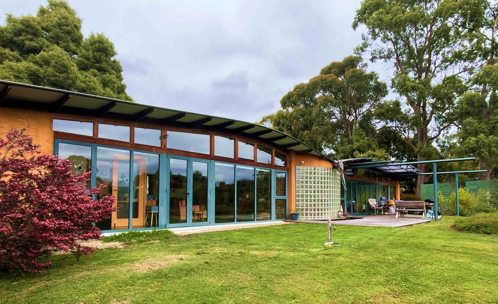 The large windows on the sunny side of the house reach down the ground and provide the vast bulk of ...