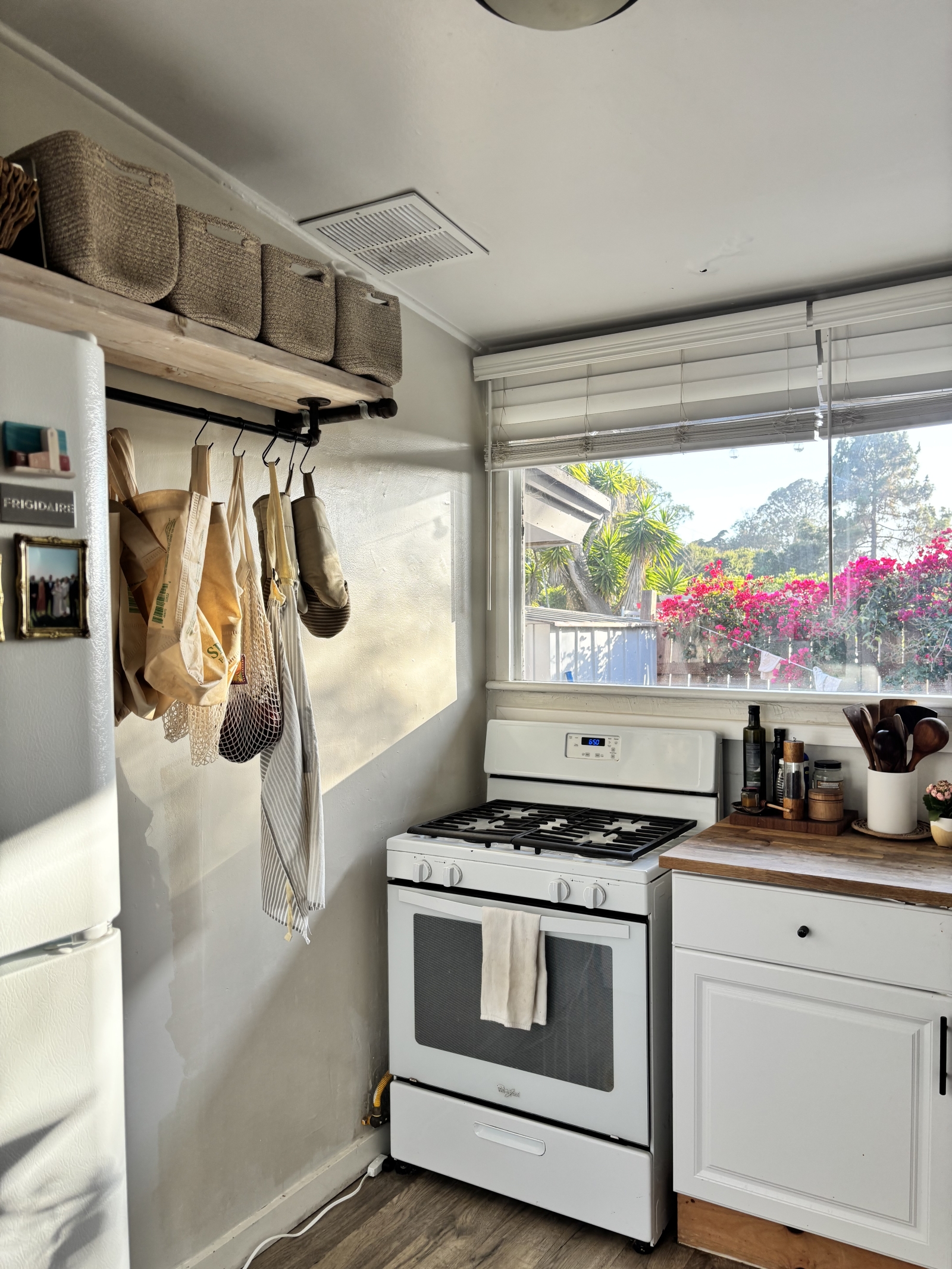 Kitchen with stove and fridge and patio view