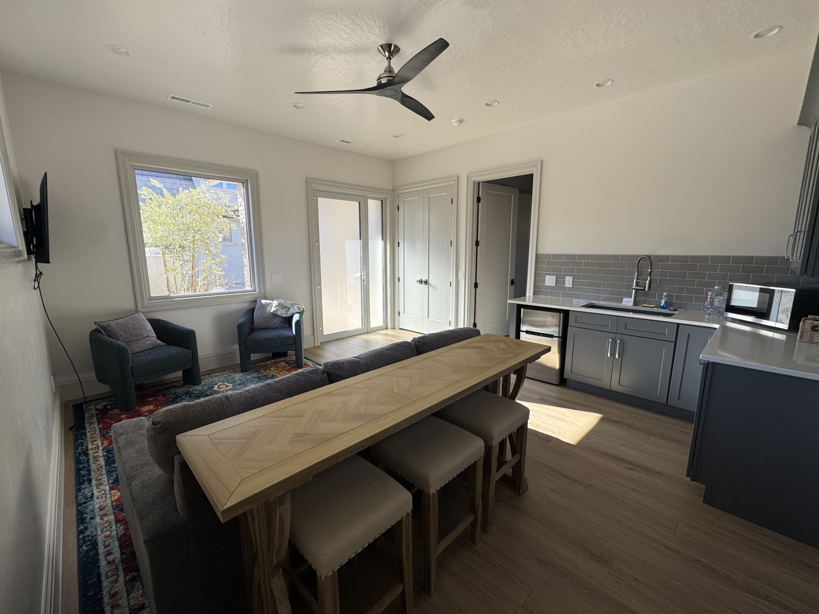 Grande Chambre : table canapé derrière le canapé queen coucher. Ventilateur de plafond à 4 vitesses