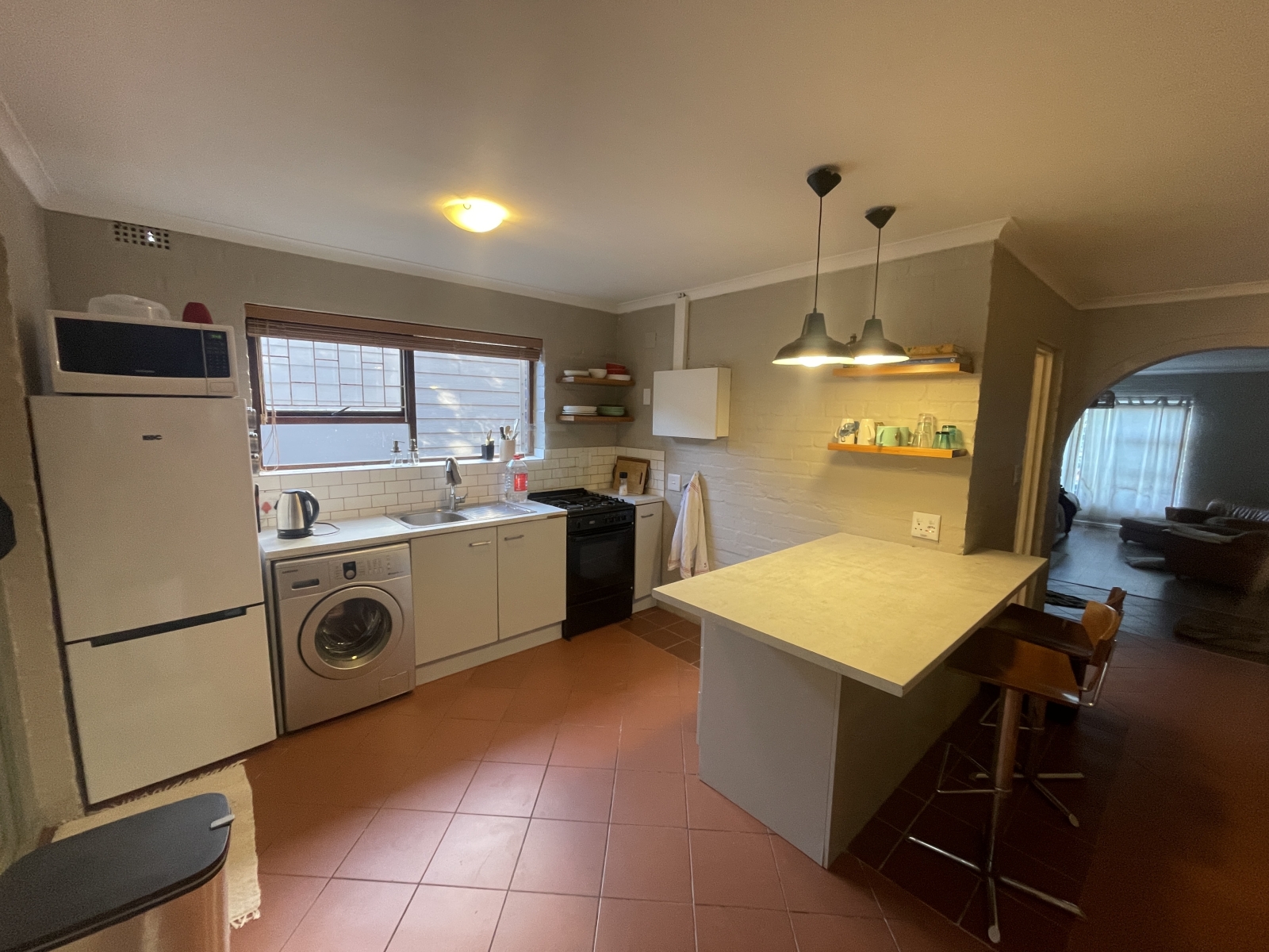 Fully equipped kitchen with washing machine.