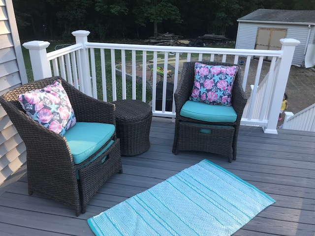 Deck and grill on patio. Below there is a fire pit.