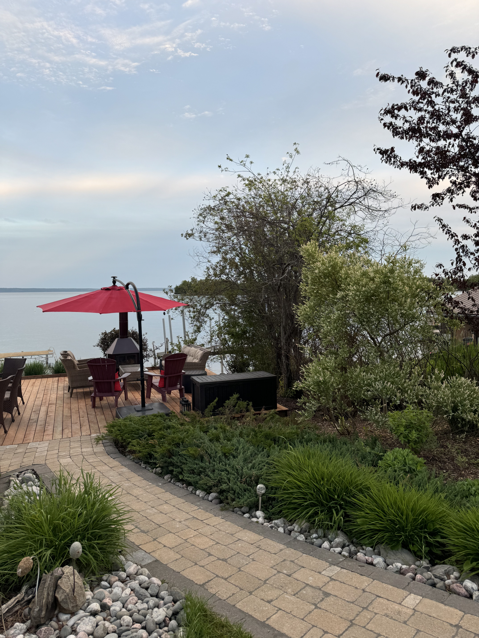 Lakeside deck sitting area with outdoor fireplace